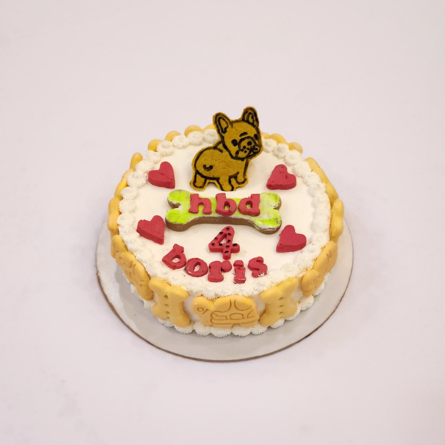 A decorated cookie cake with a dog figurine in Dehradun