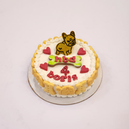 A decorated cookie cake with a dog figurine in Dehradun