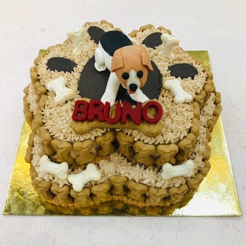 A two-tiered chicken & peanut butter cake with a dog design and the name of your dog in Dehradun